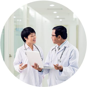 Female Male Asian Doctors Confer in Hallway Circle Doctors confer about patient NeoVista® MRI