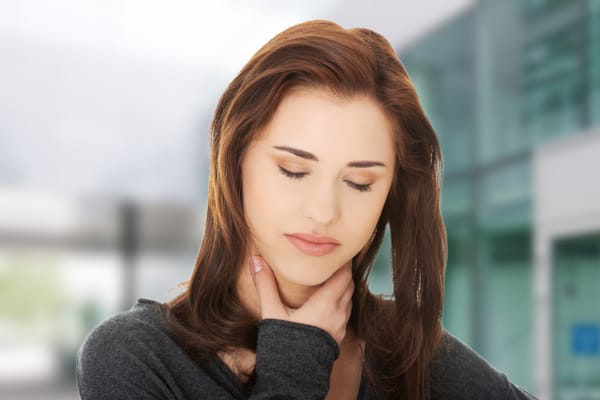 Woman Gray Sweater Holding Neck Eyes Closed Neurogenic TOS
