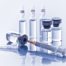 Syringe and multiple vials of clear medicine