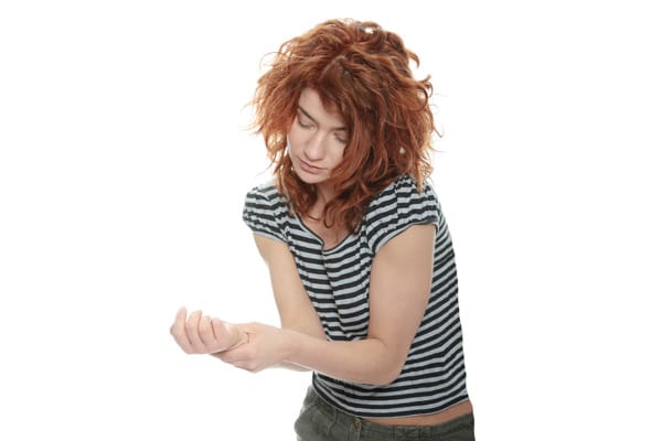 Female Red Hair Pain Hands-Crop 600 Symptoms of Arterial TOS