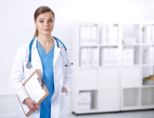 Blue-eyed female doctor scrubs, clipboard and stethoscope