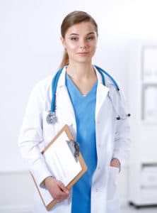Female blue-eyed surgeon holding clipboard smiling slightly can treat thoracic outlet syndrome