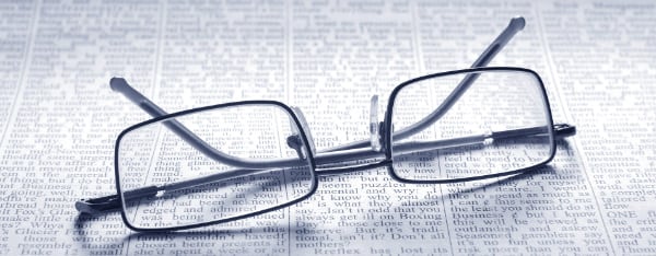 Eyeglasses on newspaper