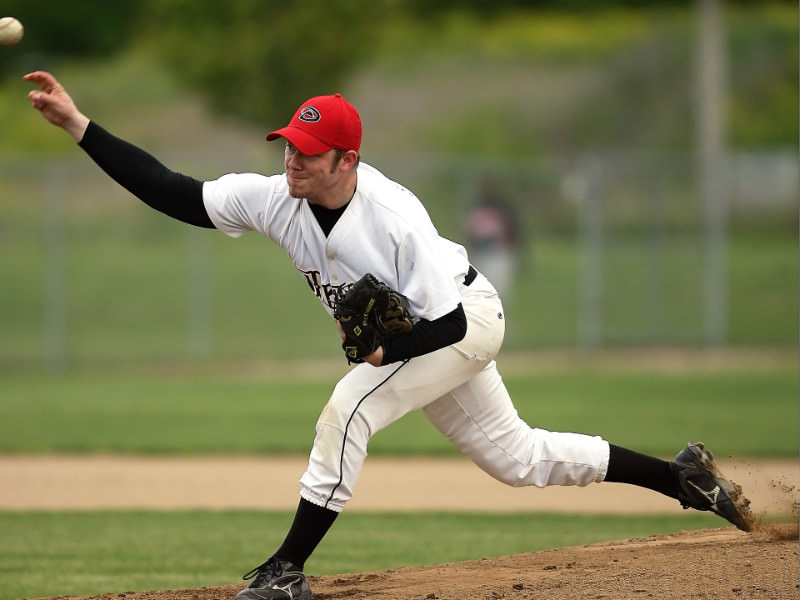 Thoracic outlet syndrome in baseball players. Major league pitcher releases baseball with intense face.