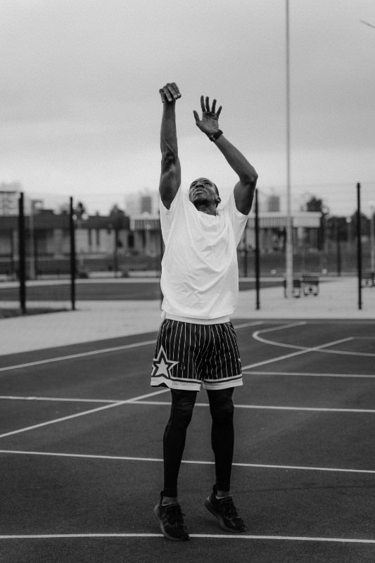 Basketball players use their arms overhead with force, often asymmetrically